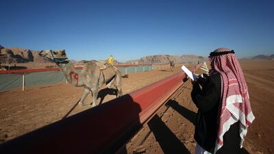 Jordanian Bedouins keep an eye on camels race using robotic jockeys in the desert of Wadi Rum valley, south of Jordan.
