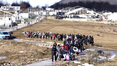 Migrants leave from the burning camp Lipa. A fire destroyed most of the camp near the city of Bihac. EPA