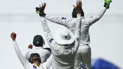 Azhar Ali of Pakistan celebrates after taking the catch off a Zulfiqar Babar delivery to dismiss Nathan Lyon and claim victory on Day 5 of the second Test in Abu Dhabi on Monday, Ryan Pierse / Getty Images / November 3, 2014