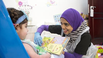 Speech therapist Nuzha Ishak works with Ghadeer Mohammed Owda, 2, at the ProVita International Medical Centre in Khalifa City, Abu Dhabi. For some long-term patients, care centre staff may be the only ‘family’ they have. Christopher Pike / The National