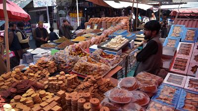 People buy dry fruits and cookies ahead of the Eid Al Fitr festival, which marks the end of Islamic holy month of Ramadan, at a market in Kabul on May 12, 2021. AFP