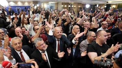 The leader of the Arab Joint List, Yousef Jabareen, centre, celebrates with supporters as the minority increased its representation in Israel's parliament. AFP