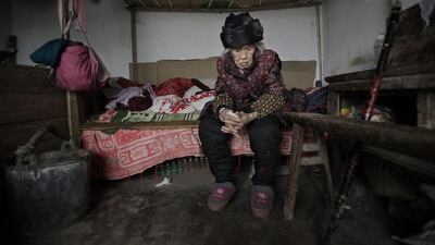 Zhang Zefang, a 94-year-old woman who sued her own children for not taking care of her, in the garage of her family's house in Fusheng Village, east of Chongqing City. Eugene Hoshiko / AP