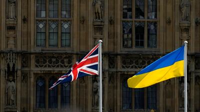 The Union Jack and Ukraine's national flag in front of the Houses of Parliament in London. AP