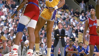 Kareem Abdul-Jabbar of the Los Angeles Lakers makes a lay-up under pressure from Benoit Benjamin of the LA Clippers in 1989. Allsport