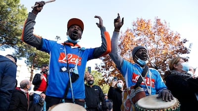 Men dressed in Napoli shirts carry drums and mourn the death if Diego Maradona. Reuters