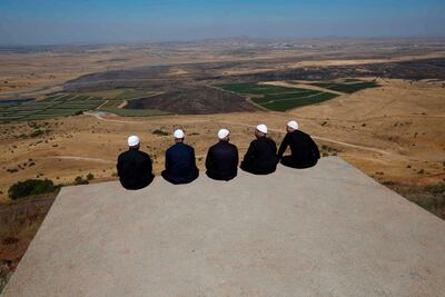Druze men at the Israeli-annexed Golan Heights sit facing Syria. AFP