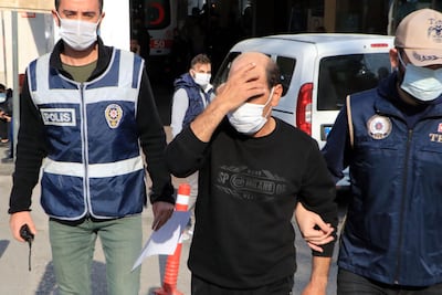 Syrian singer Omar Souleyman escorted by Turkish policemen as he leaves hospital in Sanliurfa on November 18, 2021, a day after he was arrested. AFP