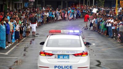 A police vehicle is seen as crowds line the streets in Suva, Fiji. Reuters