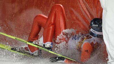 Russia's Dmitry Vassiliev crashes into the padded barrier after his first attempt during the ski jumping large hill final in Krasnaya Polyana on Saturday. Gregorio Borgia / AP
