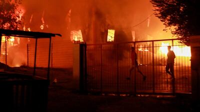 A man runs as a fire burns inside the Moria migrant camp on the island of Lesbos. AFP