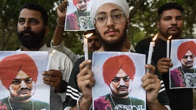People pay tribute to Punjabi singer Sidhu Moose Wala at a candlelight vigil in Amritsar, India. AFP