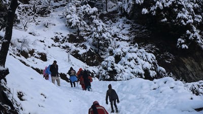 People walk on a snow-covered mountain path in Neelum valley, Pakistan-administered Kashmir. Dozens of people have been killed in avalanches and heavy snowfall in Pakistan, India and Afghanistan. EPA