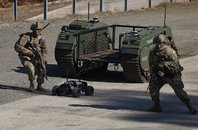 An Ark Robotics A1 UGV armed with a dummy anti-tank mine launches from a Mildred Robotics vehicle. Getty Images