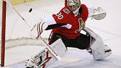 Ottawa Senators goaltender Brian Elliott makes a stick-save against the Buffalo Sabres.