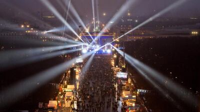 Revellers in the streets of Berlin during a light show at a stage in front of the Brandenburg Gate during the New Year's Eve party. Joerg Cartensen/EPA