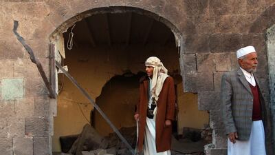 Members of the Shiite Huthi movement gather outside a building used by the Huthi police force that was damaged by a bombing in Sanaa. A bomb wounded six Shiite militiamen in the Yemeni capital, a security official said, the latest in spate of attacks on the Huthi fighters who overran Sanaa in September. Mohammed Huwais / AFP