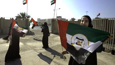 Three women who work at the women’s society school for adults in Umm al Quwain prepare for Flag Day. Jaime Puebla / The National