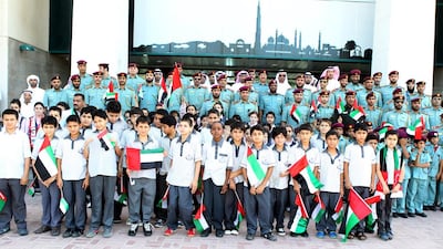 RAK Police and schoolchildren from the emirate at Flag Day celebrations. Courtesy RAK Police