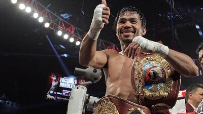 Manny Pacquiao gestures to fans as he celebrates after defeating Timothy Bradley in a 12 round unanimous decision at the MGM Grand Arena on April 9, 2016 in Las Vegas, Nevada. Pacquiao captured the WBO International Welterweight Title. AFP / John GURZINSKI