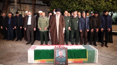 Iranian supreme leader Ayatollah Ali Khamenei prays at the coffin of Islamic Revolution Guards Corps military adviser Razi Mousavi, in Tehran on December 28. Iranian supreme leader's office