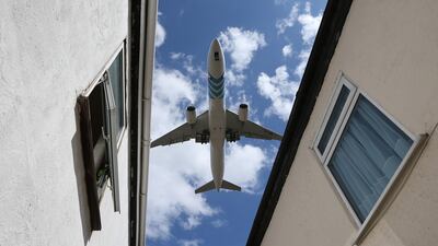 A passenger jet comes in to land over houses next to Heathrow airport. Getty Images