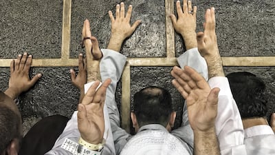 Muslim Hajj pilgrims touch Kaaba's wall and pray around the holy Kaaba at the Grand Mosque in Mecca, Saudi Arabia. EPA