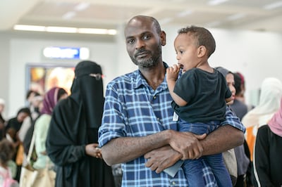 Emad Hassan and his family landed at Abu Dhabi International Airport on Sunday. Khushnum Bhandari / The National