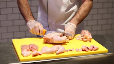 Michiel Smit prepares some chicken at the meat counter.