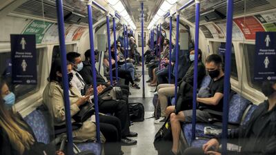 Commuters ride on the underground on September 24 in London. Getty Images
