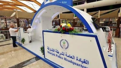 Police officer Jasim Mohammed Al Kalbani gives a visitor information about his vehicle registration at the mall station. Charles Crowell for The National