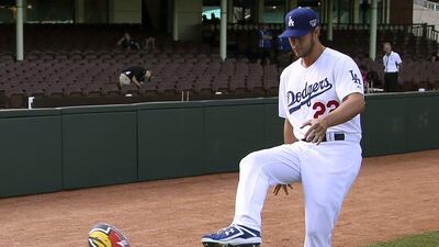 The Los Angeles Dodgers' Clayton Kershaw kicks a rugby league ball at the Sydney Cricket Ground on Wednesday. Rick Rycroft / AP / March 19, 2014.