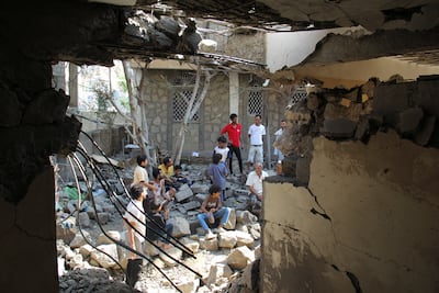 People inspect damage to a house reportedly hit by a Houthi missile in Taiz, Yemen. Reuters