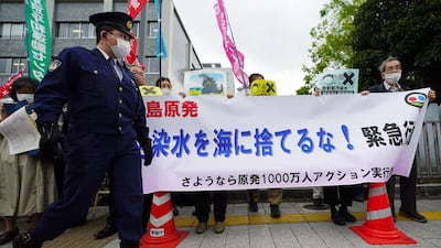 People hold a banner that reads "Don't dump radioactive water into the sea" during a rally outside the prime minister's office in Tokyo. AP