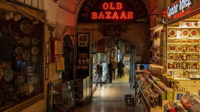 A shopkeeper waits for customers in an alleyway of the Grand Bazaar in Istanbul