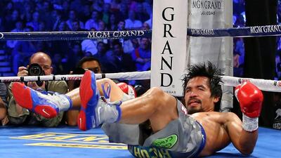 Manny Pacquiao is knocked down in the third round while taking on Juan Manuel Marquez during their welterweight bout. Al Bello / Getty Images