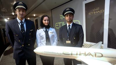 Faisal Obaid Al Naqbi, left, Aisha Al Mansoori and Hassan Al Bloushi are Emiratis who graduated from the Etihad Airways Training Academy. Sammy Dallal / The National