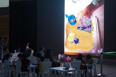 Movie goers watch a film at Cinema in the Park at Umm Al Emarat Park.