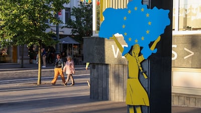 A mural of a girl holding a map of Ukraine aloft, in Vilnius. Bloomberg