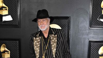 Mick Fleetwood wears a pinstripe blazer with gold lapels and his signature hat. AFP