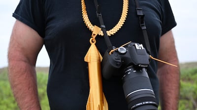 A person wears a necklace featuring Starship ahead of its flight test. AFP