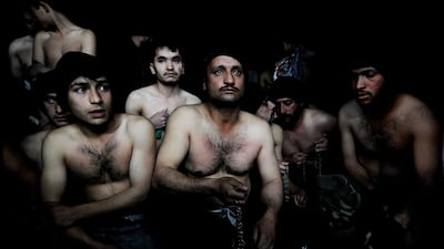 Men hold chains as they wait to take part in ritual self-flagellation to celebrate Ashura, at a mosque in Kabul. January 15, 2008. Shah Marai / AFP