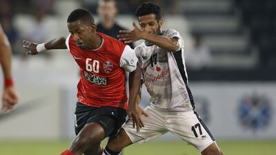 Al Ahli defender Basheer Saeed, left, moves to Al Jazira with the league leaders having problems in defence. Fadi Al Assaad / Reuters