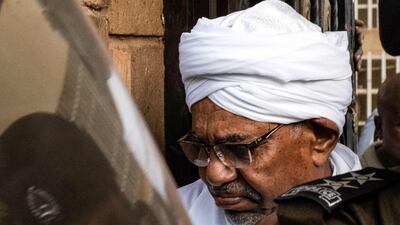Omar Al Bashir is escorted back to prison after a court appearance on charges of corruption and illegal possession of foreign currency, in Khartoum. AFP
