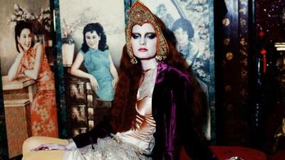 Coat, Dh1,994, Jigsaw. Dress, Dh3,017, Peridot. Tights, stylist’s own. Head prop, price on request, Tomihiro Kono. Rings, stylist’s own