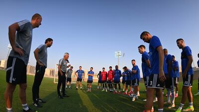 UAE manager Bert van Marwijk speaks to the players during the training session.