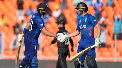 England's captain Jos Butler, right, congratulates teammate Joe Root on reaching his half century. AP