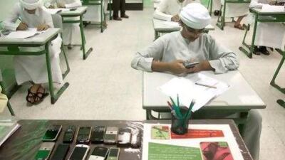 Students hand in their mobile phones before taking their year-end examinations last year in the Northern Emirates.