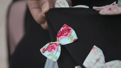 The wearer of this abaya, who did not want to give her name, says her sister designs abayas for her female relatives. “She likes ribbons, she’s my sister. Design depends on the person, first of all,” says the Emirati, 19, from Abu Dhabi. “The cut of the abaya changes every three or four months. The winter abaya differs from the summer or spring in fabrics and colour.”