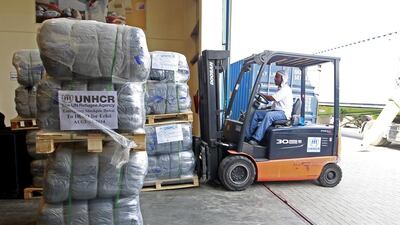 Blankets are loaded for shipping from the UNHCR stockpiles at International Humanitarian City in Dubai to Iraqi Kurdistan. Jeffrey E Biteng / The National